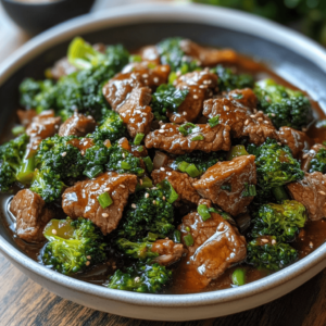 Chinese beef and broccoli represents comfort food at its finest—tender strips of marinated beef paired with vibrant green broccoli, all brought together in a glossy, savory sauce that clings perfectly to each ingredient.